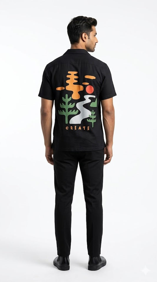 Person wearing a black t-shirt with colorful graphics on the back, standing against a white background